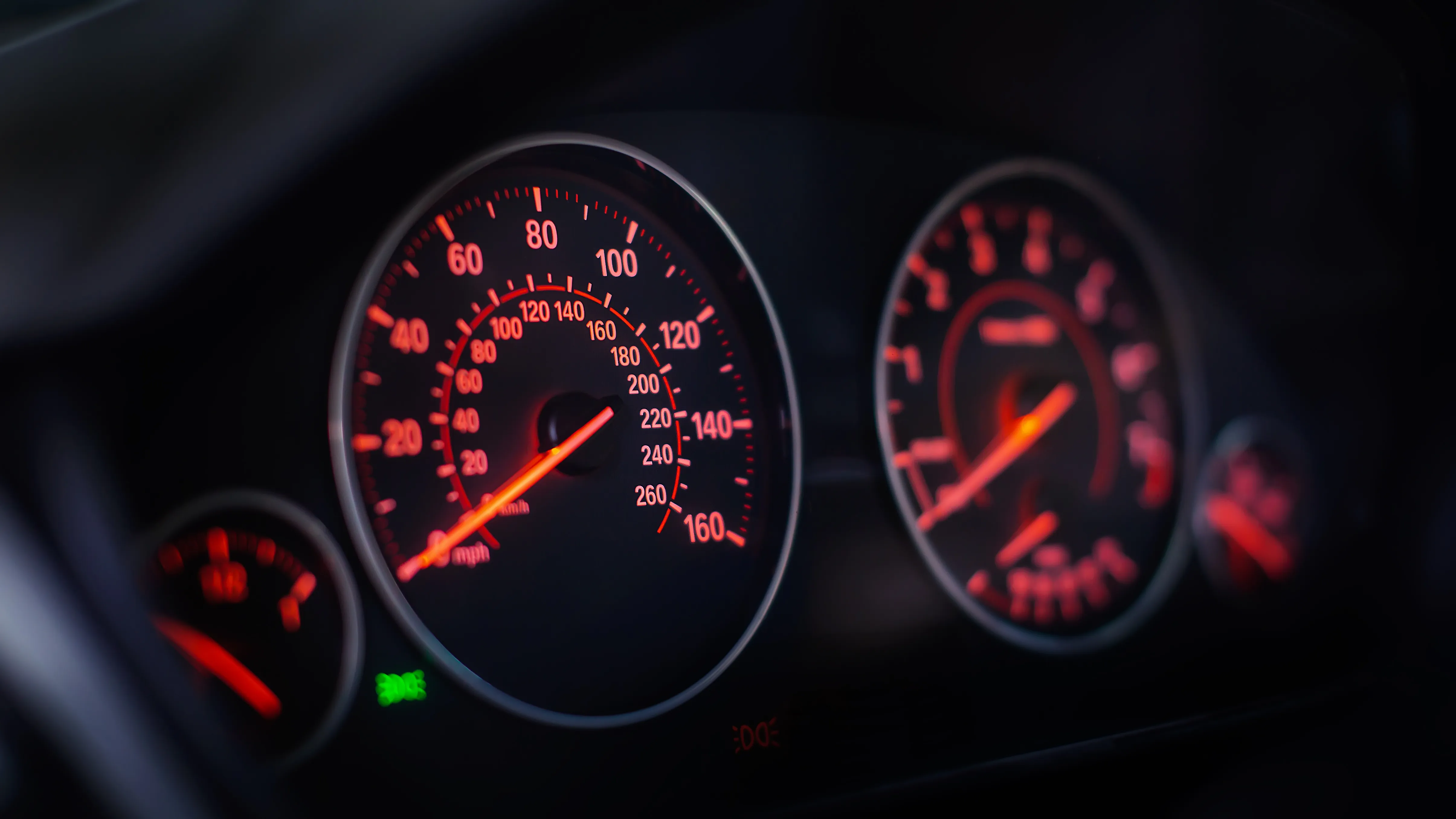 Modern car dashboard showing miles per hour and mileage