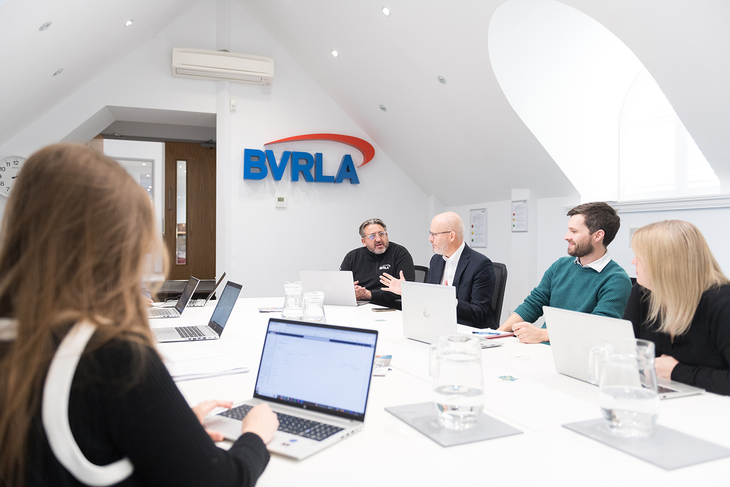 Group of people sitting around large table in the Boardroom in BVRLA offices