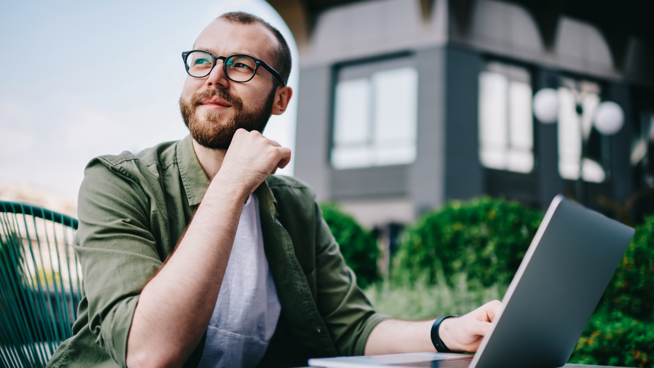 man sitting at a laptop