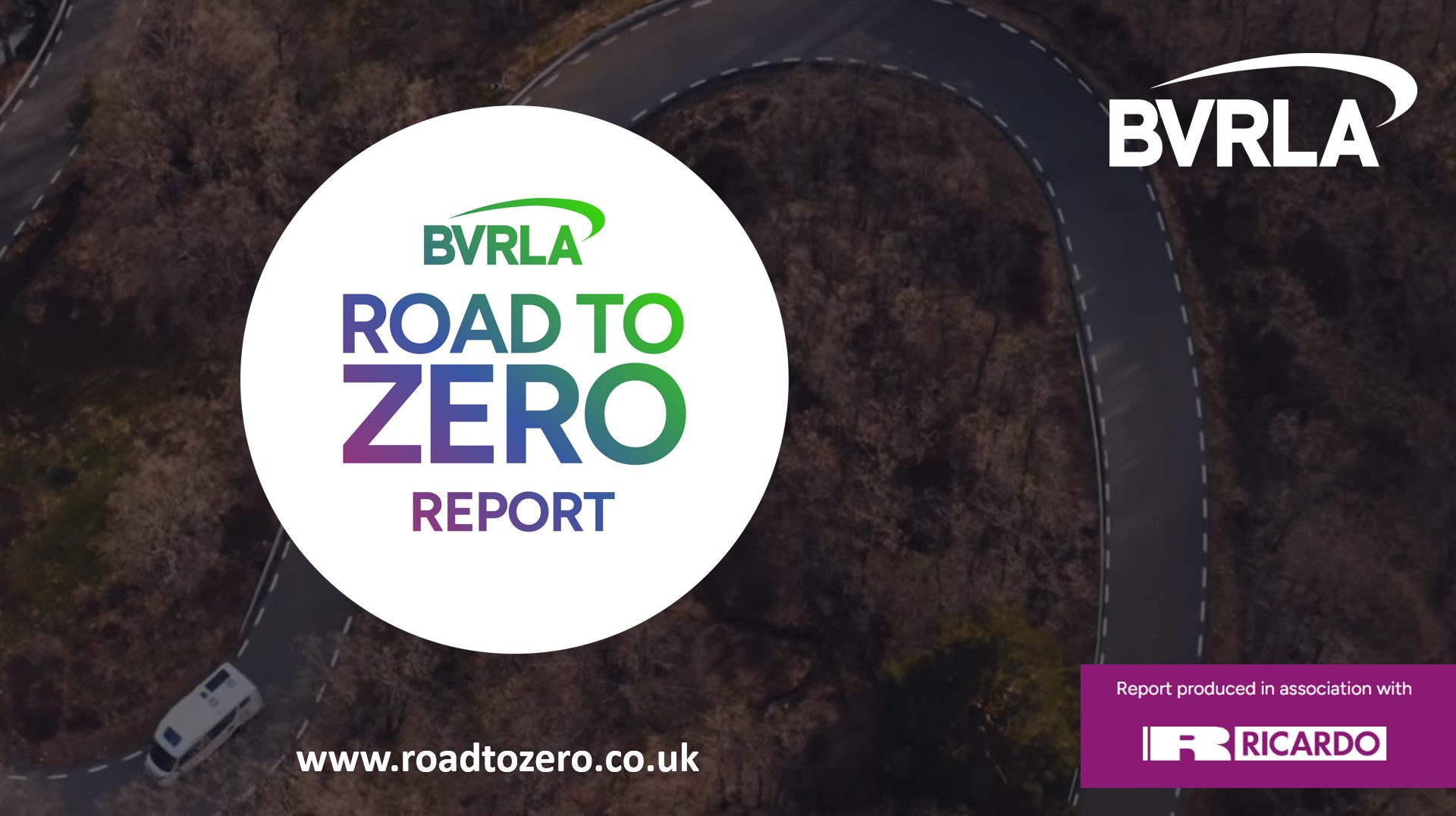 Image of country road faded into the background, with a prominent logo for the BVRLA Road to Zero Report card in a white circle in the foreground. Logo is gradient from purple, through blue into green